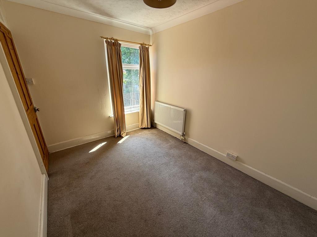 Lot: 116 - END-TERRACE HOUSE WITH PARKING - Bedroom two with window to the rear
